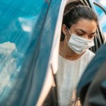 woman-getting-into-her-car-with-a-protection-mask-royalty-free-image-1620925058.jpeg